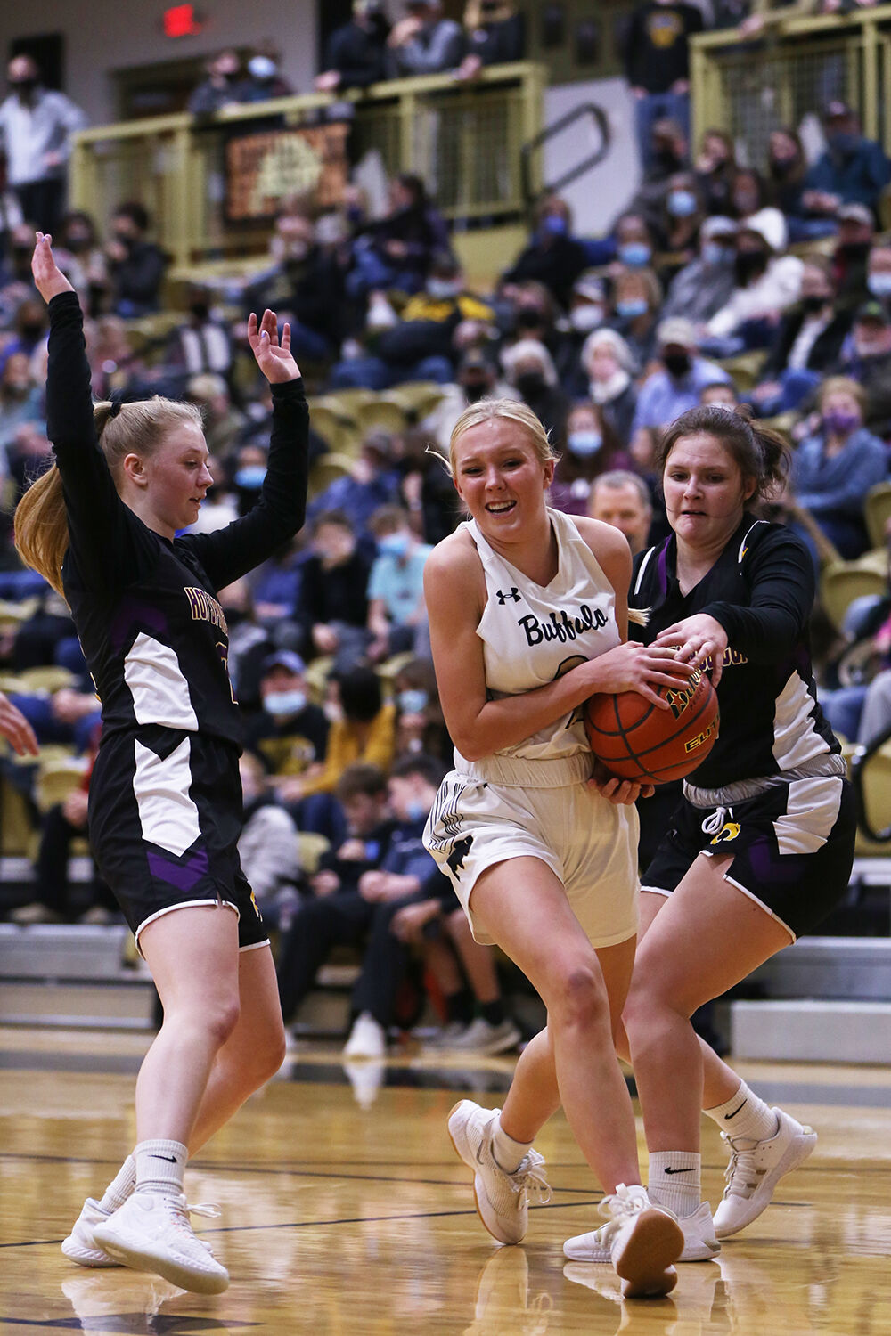 Kendall Tietjen rips the ball through two Thermopolis defenders